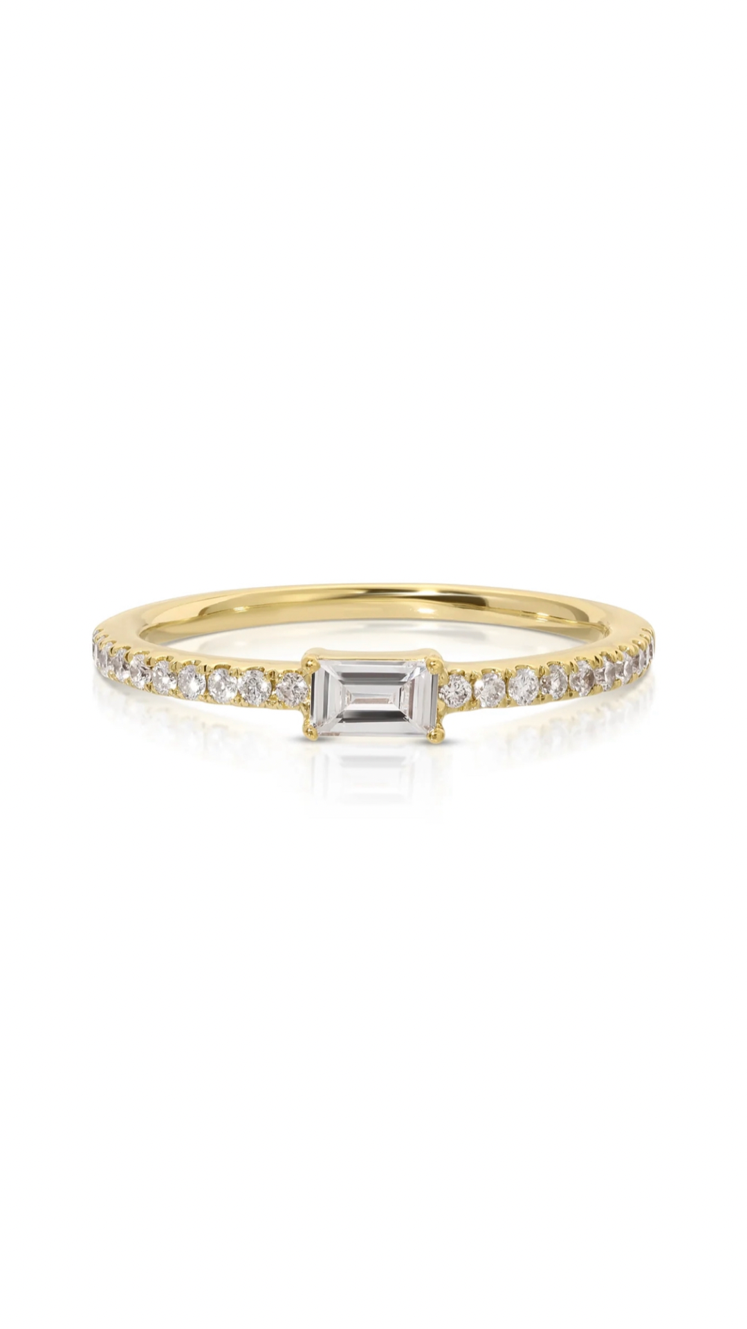 This exquisite ring features a delicate .10 carat baguette diamond at the center, complemented by a classic 14k yellow gold band encrusted with 0.10 carats of round diamonds. Expertly crafted with a stunning design, this piece is a perfect choice for any occasion.