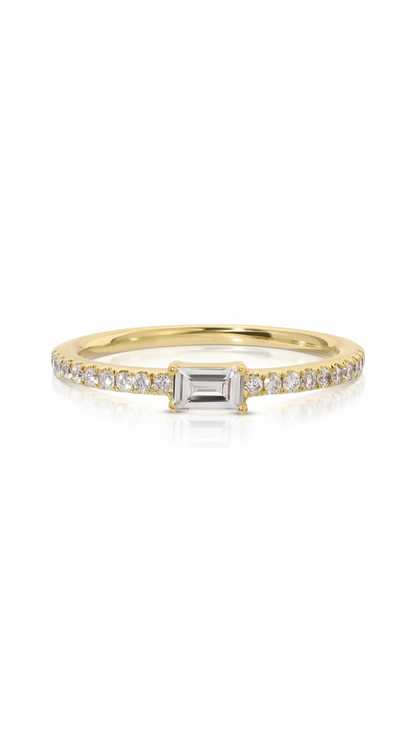 This exquisite ring features a delicate .10 carat baguette diamond at the center, complemented by a classic 14k yellow gold band encrusted with 0.10 carats of round diamonds. Expertly crafted with a stunning design, this piece is a perfect choice for any occasion.